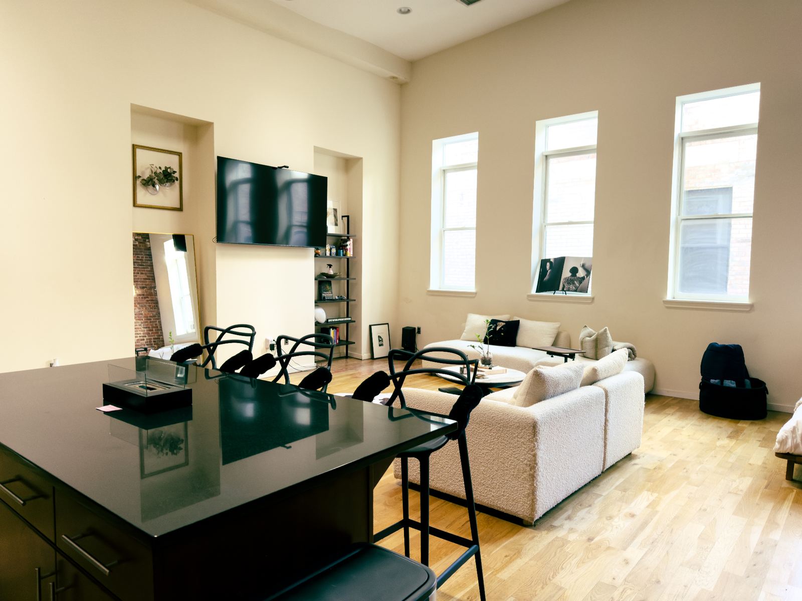 Sunlit great room with kitchen island and lounge seating