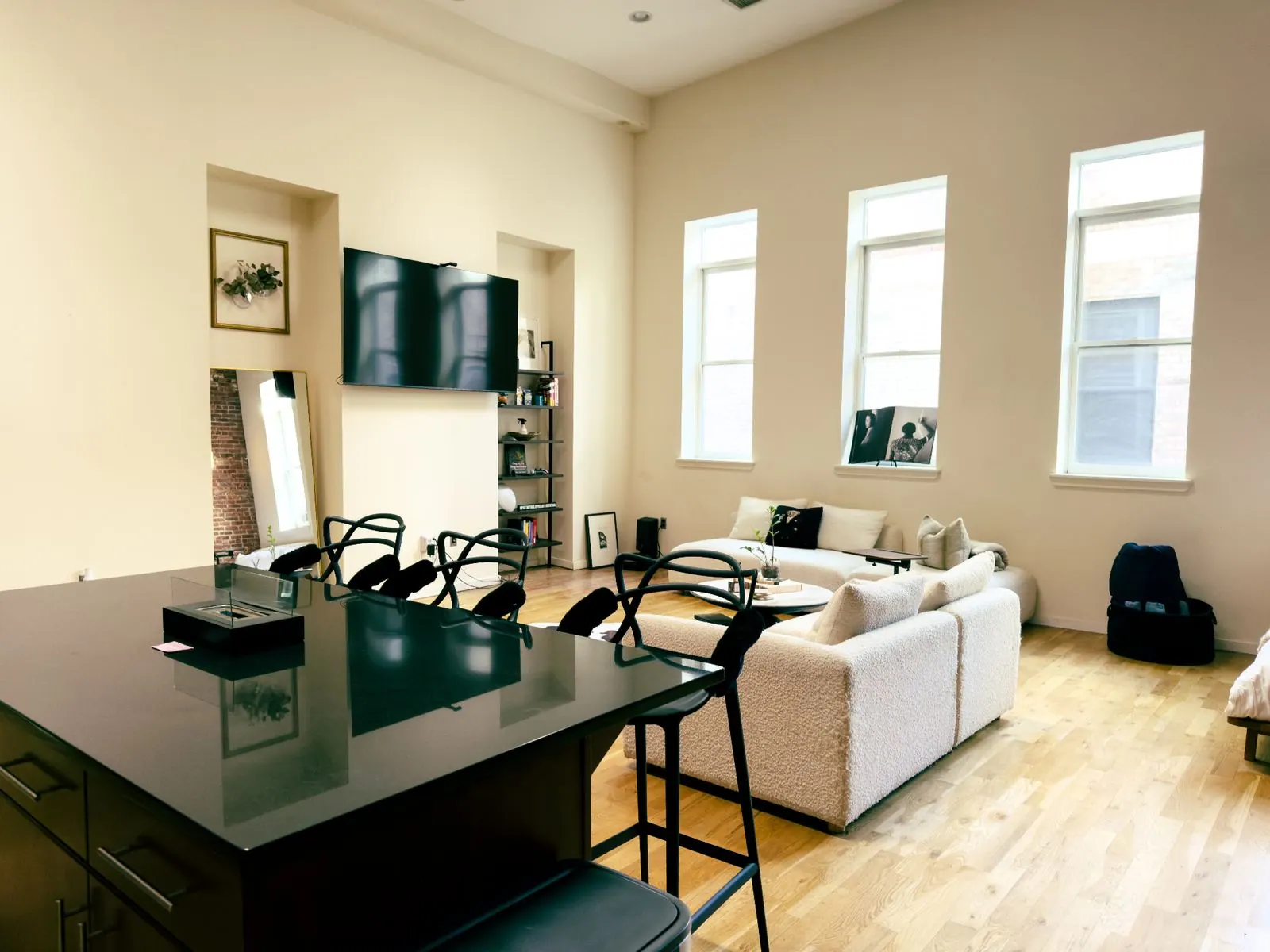 Sunlit great room with kitchen island and lounge seating