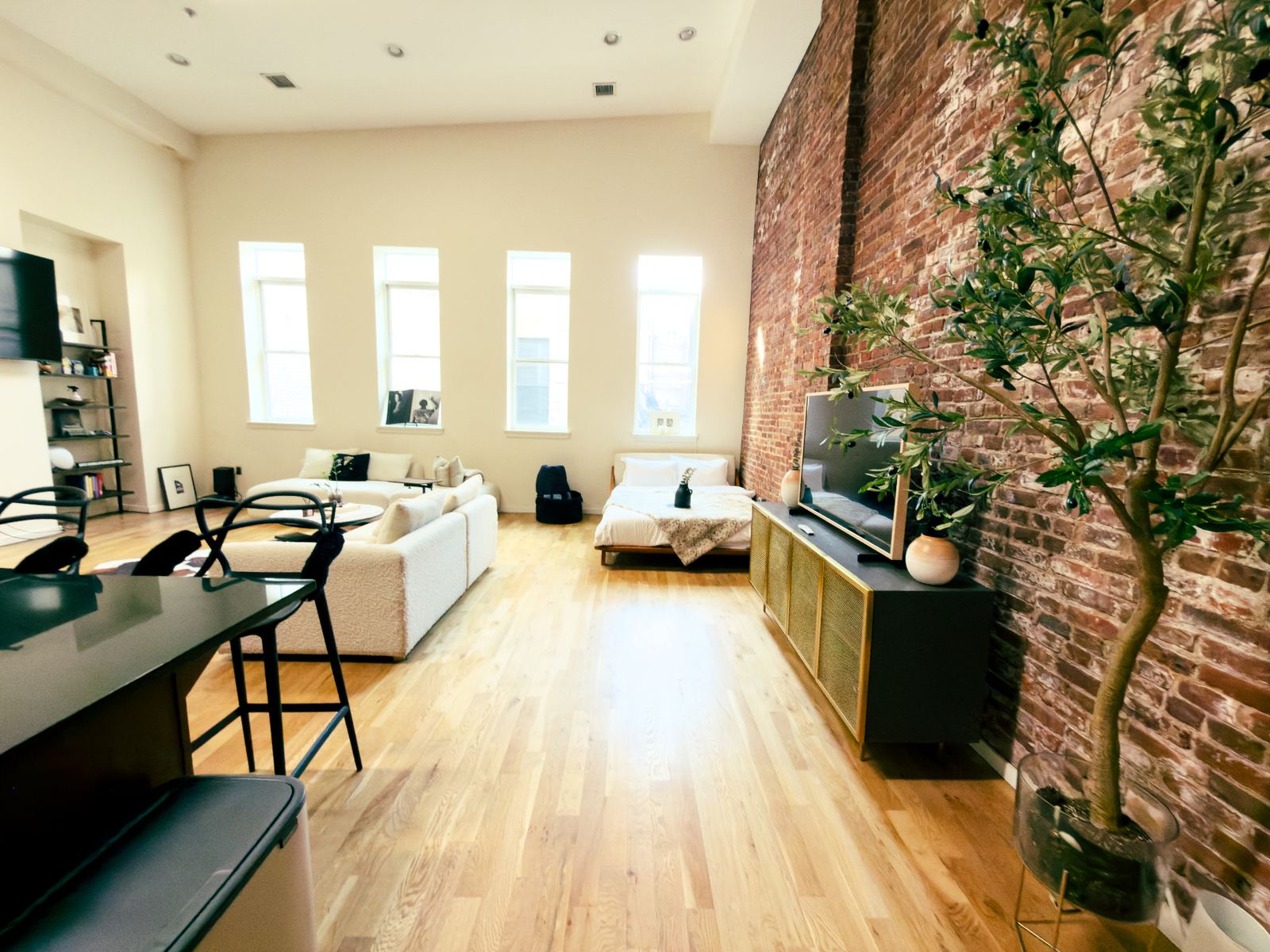 Open-plan living with soaring ceilings and exposed brick